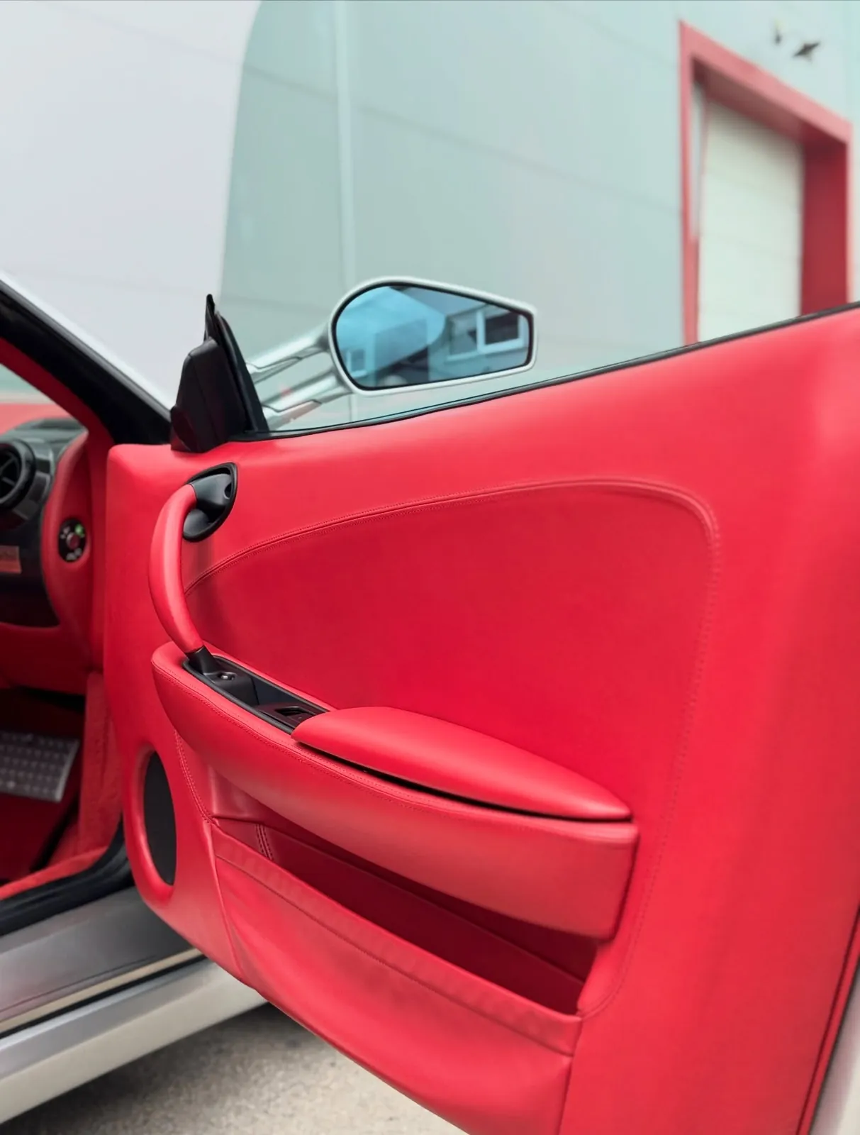 Vyčistená a ošetrená červená koža na dverách Ferrari F430